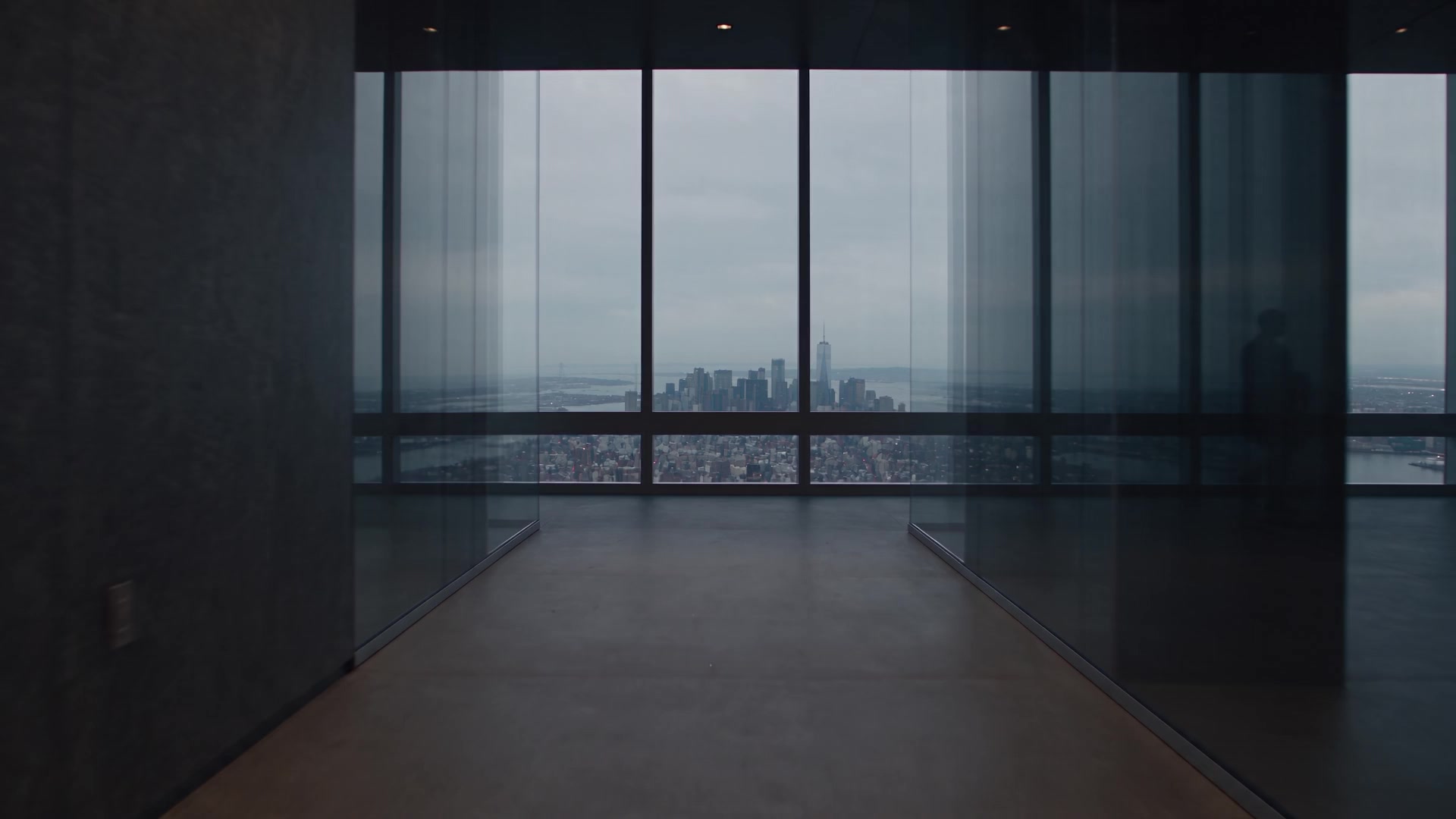 An office floor at blue hour looking out over a financial district