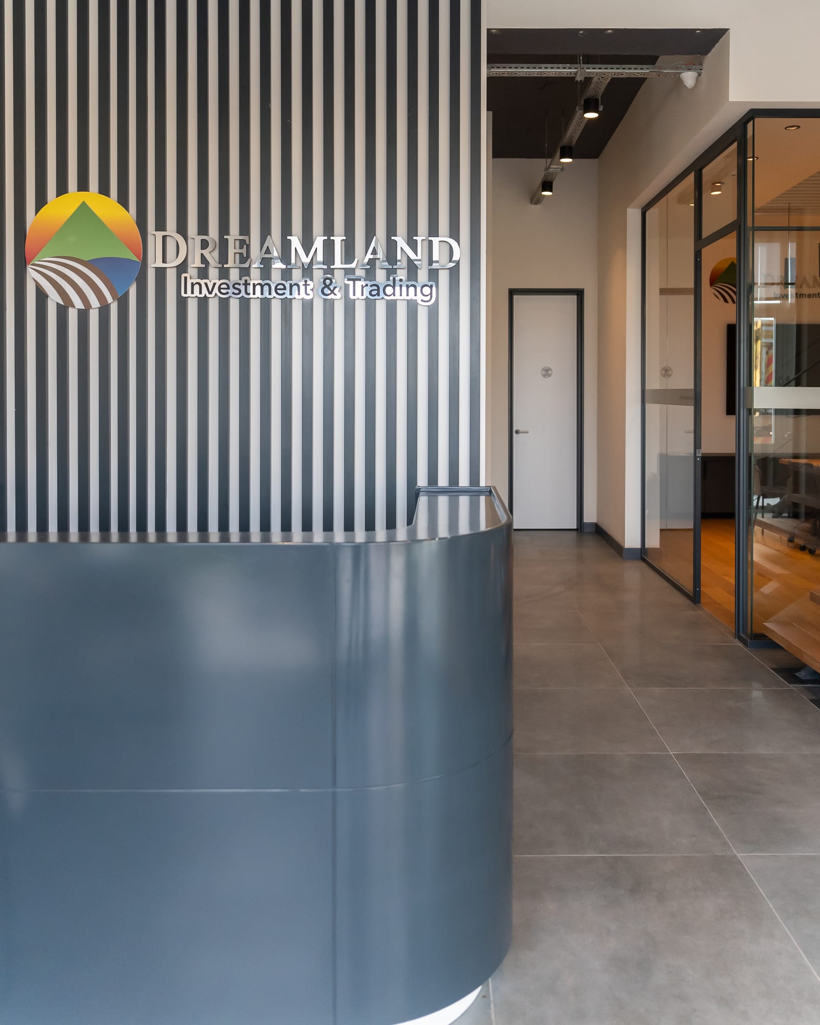 Dreamland reception: the Dreamland mark on a fluted wall behind the front desk